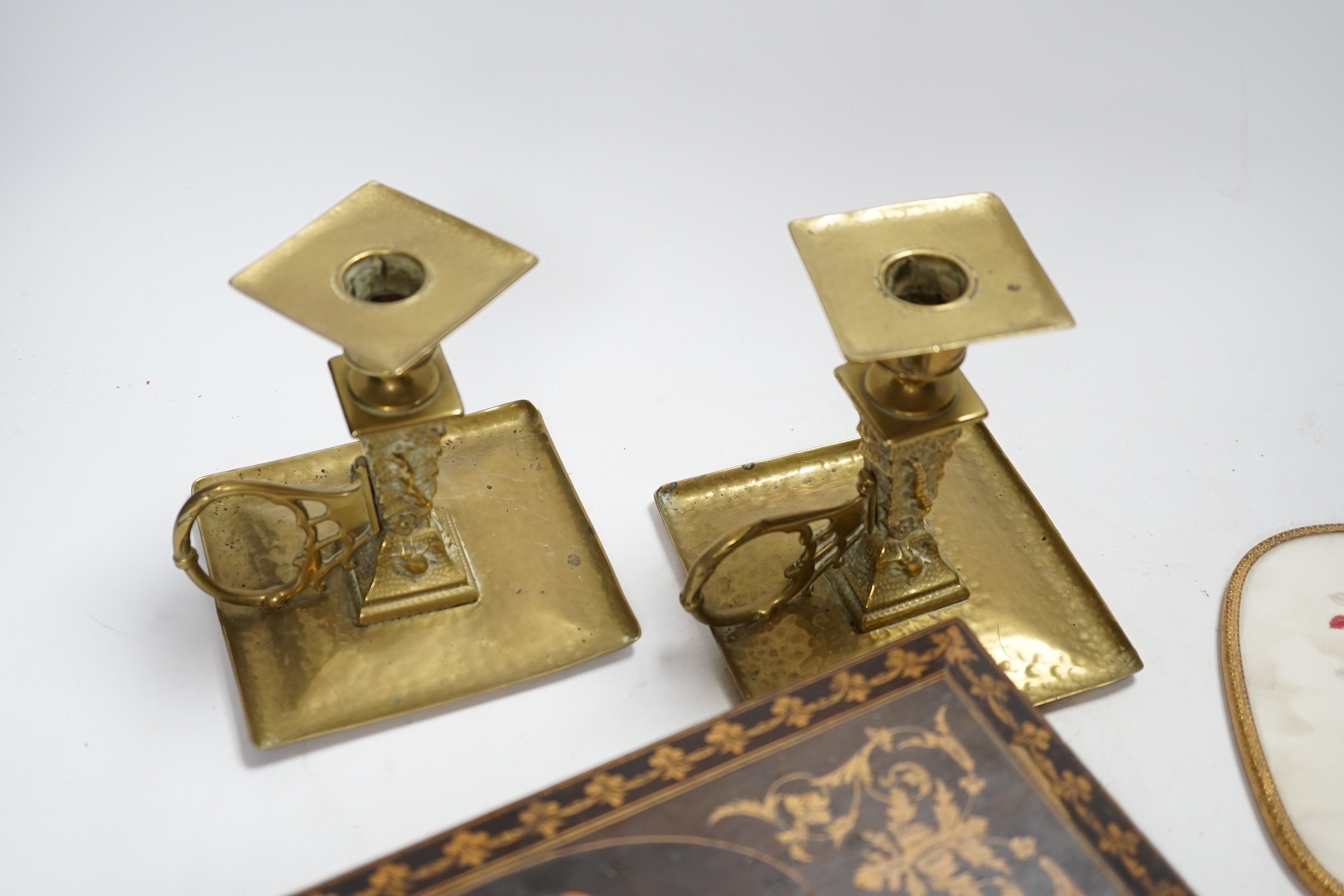 An inlaid Sorrento style box, a gilt hand mirror with enamel cartouche, a pair of brass candle holders and another hand mirror, box 30cm wide